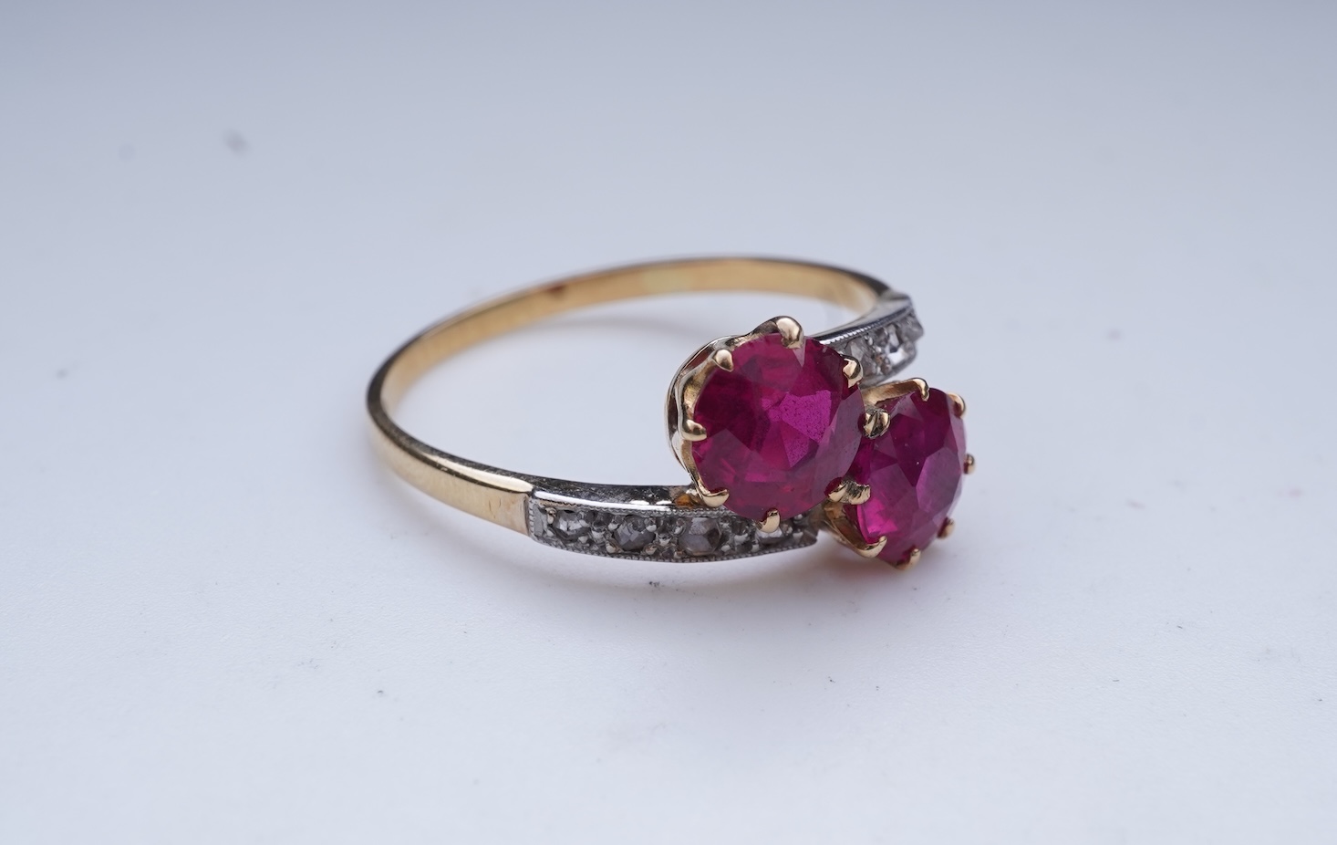 A synthetic ruby and diamond 'toi-et-moi' ring, early 20th century